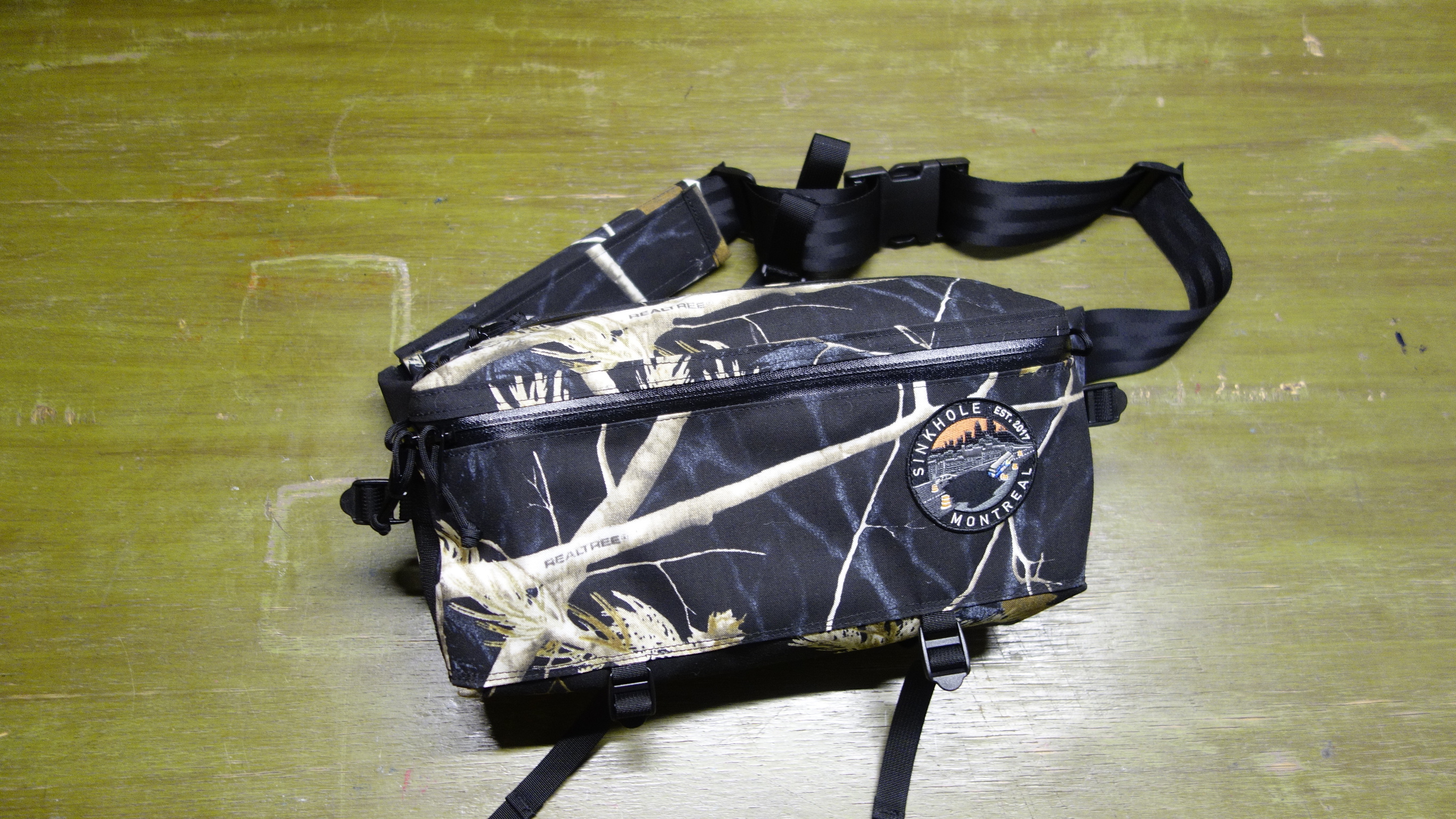 XL fannypack with a black realtree camo pattern